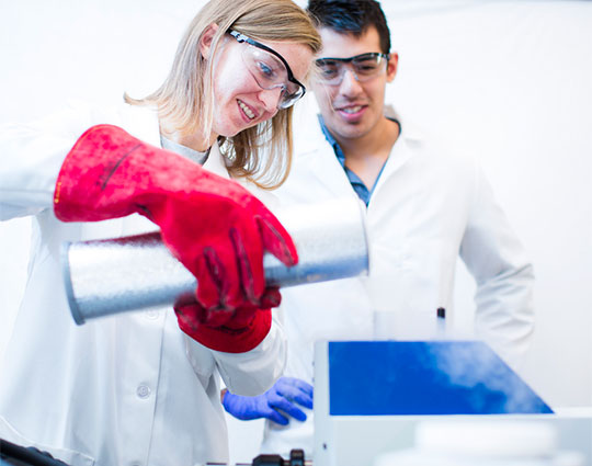 Two students conducting a chemistry experience.