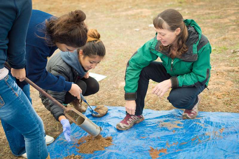 Peggy O'Day and students in the field