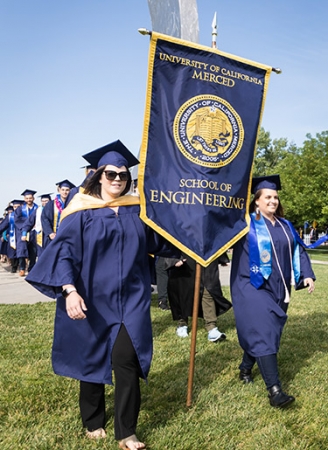 Bethany Trinidade ('09) and Heather Hopkins ('09) return to UC Merced as flag bearers at the spring 2019 commencement for the schools of Natural Sciences and Engineering.